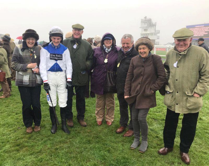 Huddled against the inclement weather.. owners of Knockanrawley in the paddock