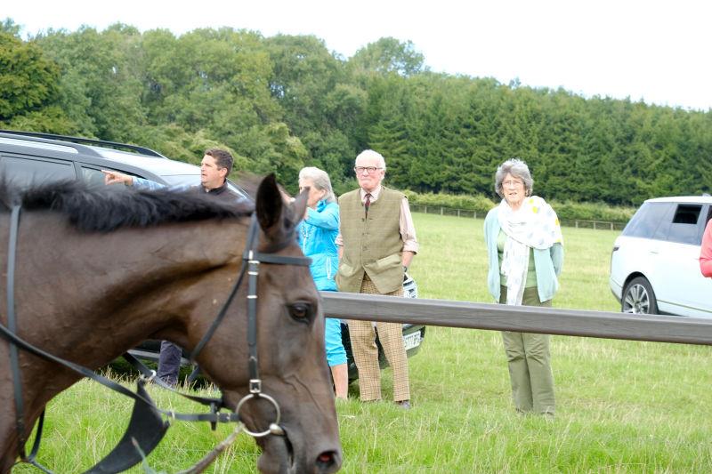 Sandra, Philip and Nannette watching their horses come down the gallop