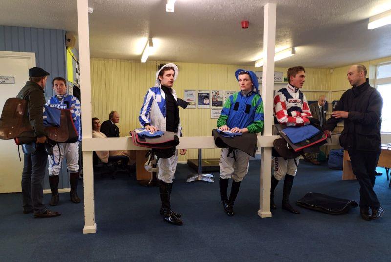 The weighing room.. Happy looking jockeys David Bass and Mikey Hamill waiting to weigh out..