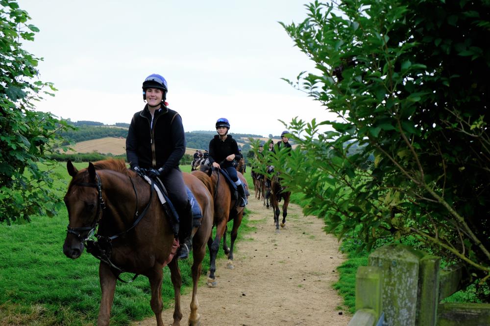 Red River and Mary Cookson leading the string back from the sand gallops
