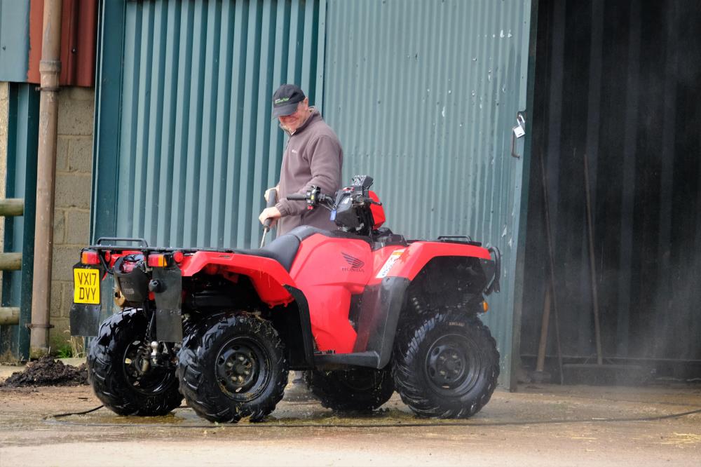 Gordon steam cleaning his old quad bike in preparation for his new one..