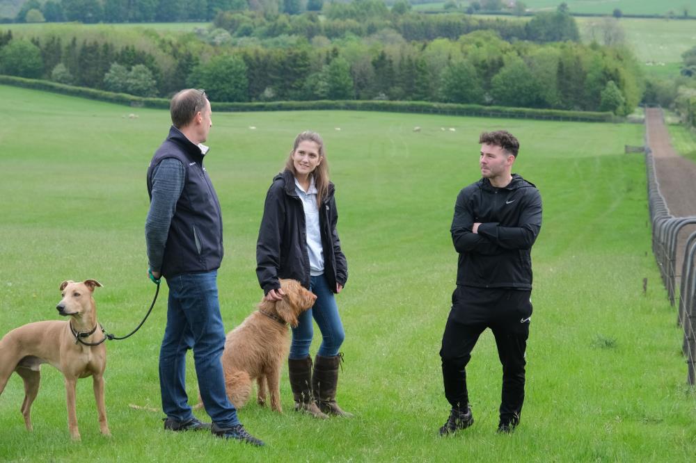 Dog handlers.. Peter with Gemma and Jack..waiting to watch the horses on the gallops