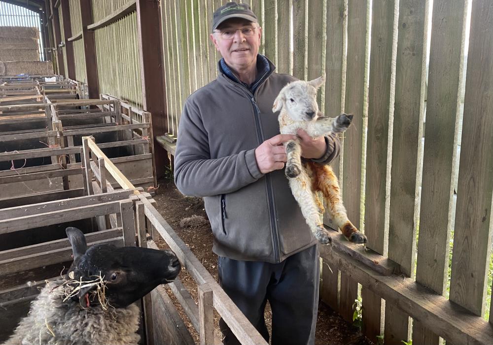 Gordon with Thorndale's first lamb of the year.. 5 days early..