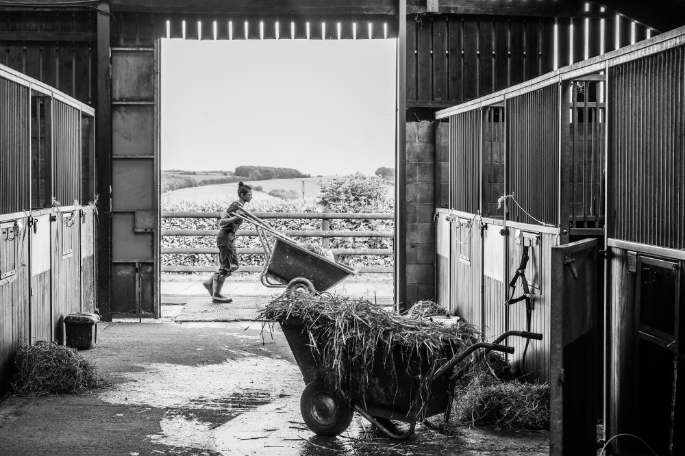 Aamilah passing the barn with her barrow..