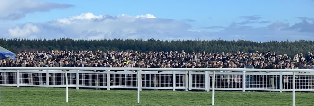 3000 plus students on the far side of the racecourse at Exeter yesterday